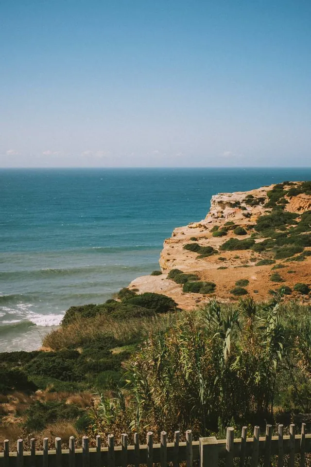 Atlantic cliffs seen through a slatted fence